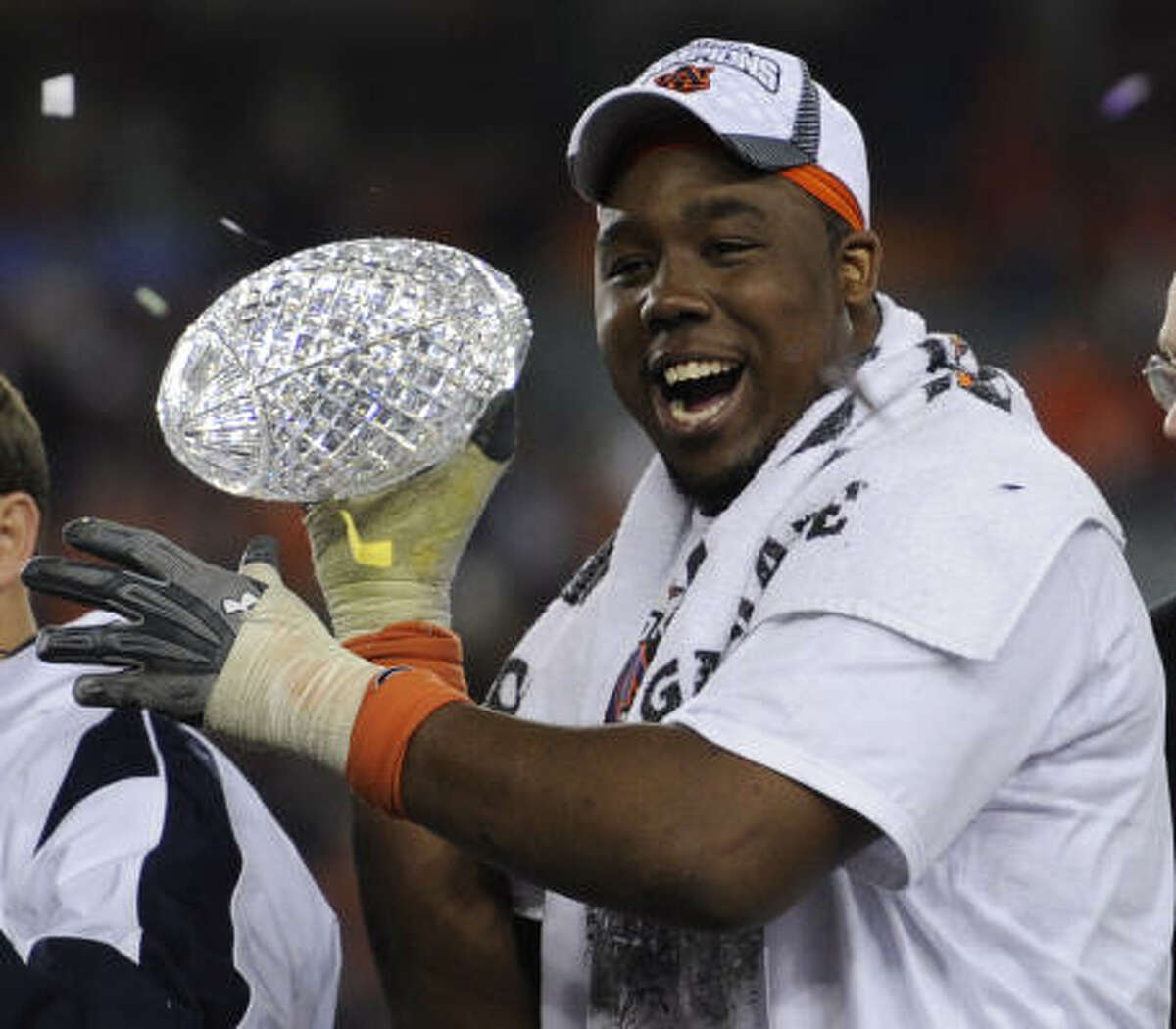 Auburn's Nick Fairley celebrates with the Coaches' Trophy.