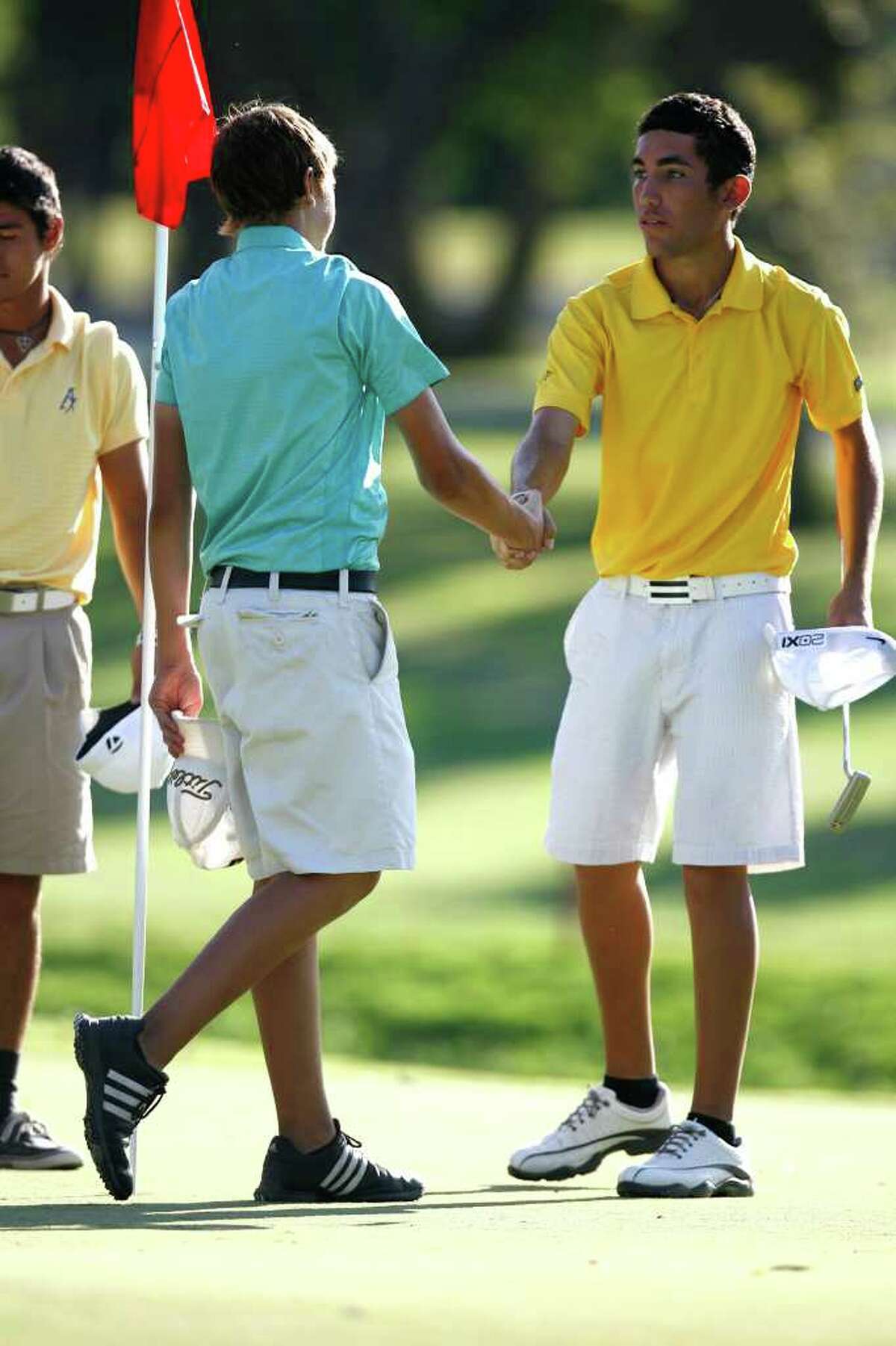 Chris Schriedel, who placed second, congratulates boys champion Alex Bissaro after the Greater San Antonio Junior Championship at Brackenridge Golf Course on Thursday, July 28, 2011. Bissaro gained the title after losing on the final hole last year.