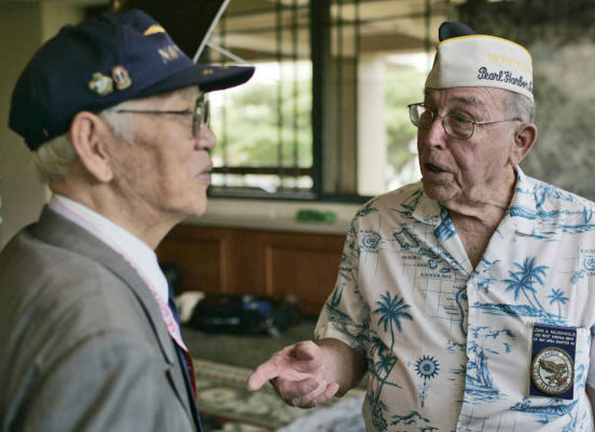 Pearl Harbor survivor John Rauschkolb, 85, right, meets former Japanese Navy aviator Takeshi Maeda, also 85, at Sunday's opening of Pearl Harbor's 65th anniversary symposium in Honolulu.