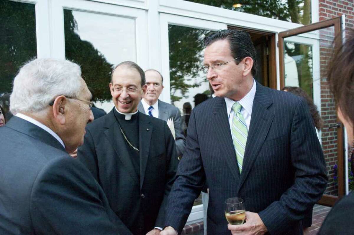 Governor Dannel P. Malloy greets Nobel Prize winner and former Secretary of State Henry Kissinger as Bishop Lori looks on at Robert Dilenschneider's home in Darien, Conn., July 28, 2011. Kissinger discussed his new book "On China."