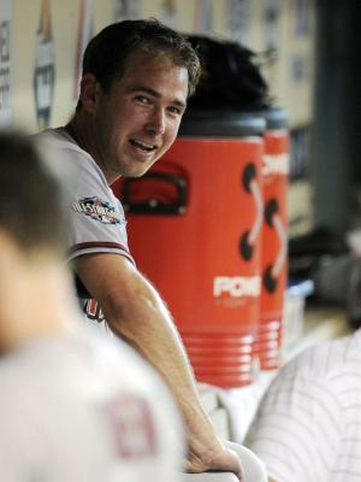 Diamondbacks pitcher Zach Duke smiles in the dugout after hitting a three-run home run.