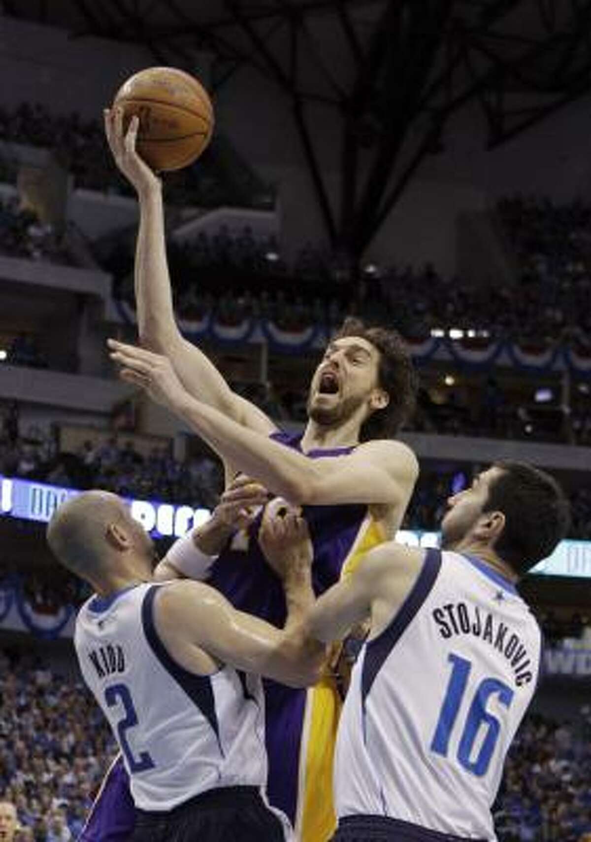 Lakers forward Pau Gasol shoots over Mavericks guard Jason Kidd and forward Peja Stojakovic.