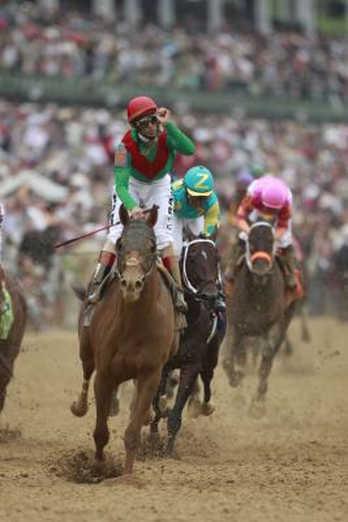 Jockey John R. Velazquez kisses his fist after riding Animal Kingdom to victory in the 137th Kentucky Derby.