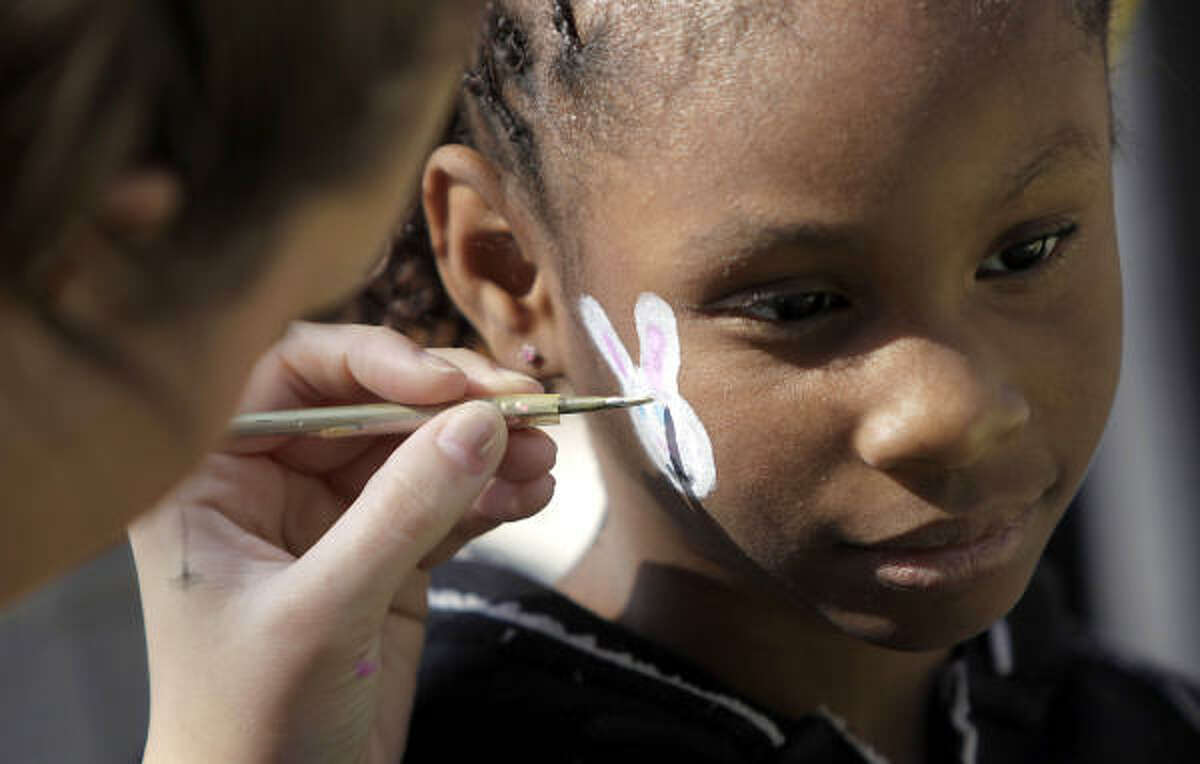 Brianna Underwood, 7 gets her face painted with a bunny at The Lighthouse of Houston Community Services Center.