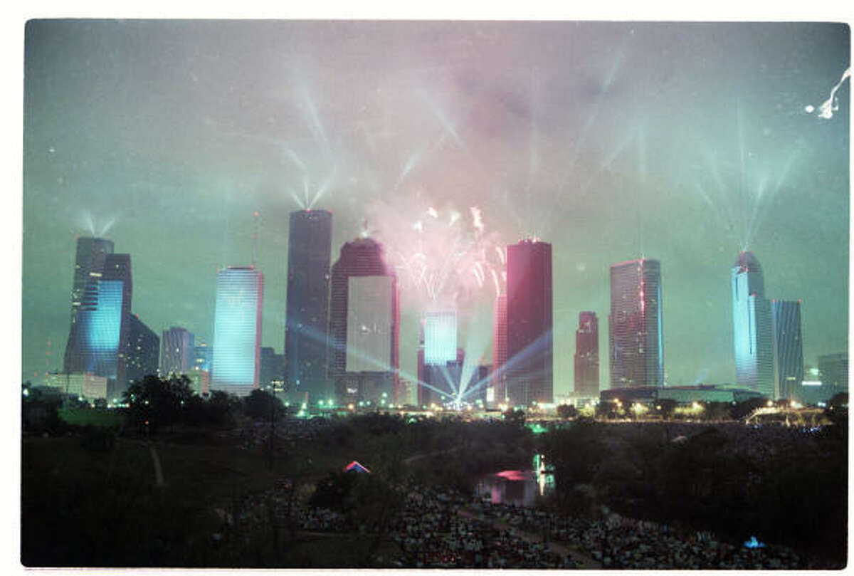 Fireworks burst over the Houston skyline, laser beams play through the night sky and the city's buildings become screens for slides during Jean-Michel Jarre's "Rendezvous Houston: A City In Concert" laser light show on Saturday, April 5, 1986.