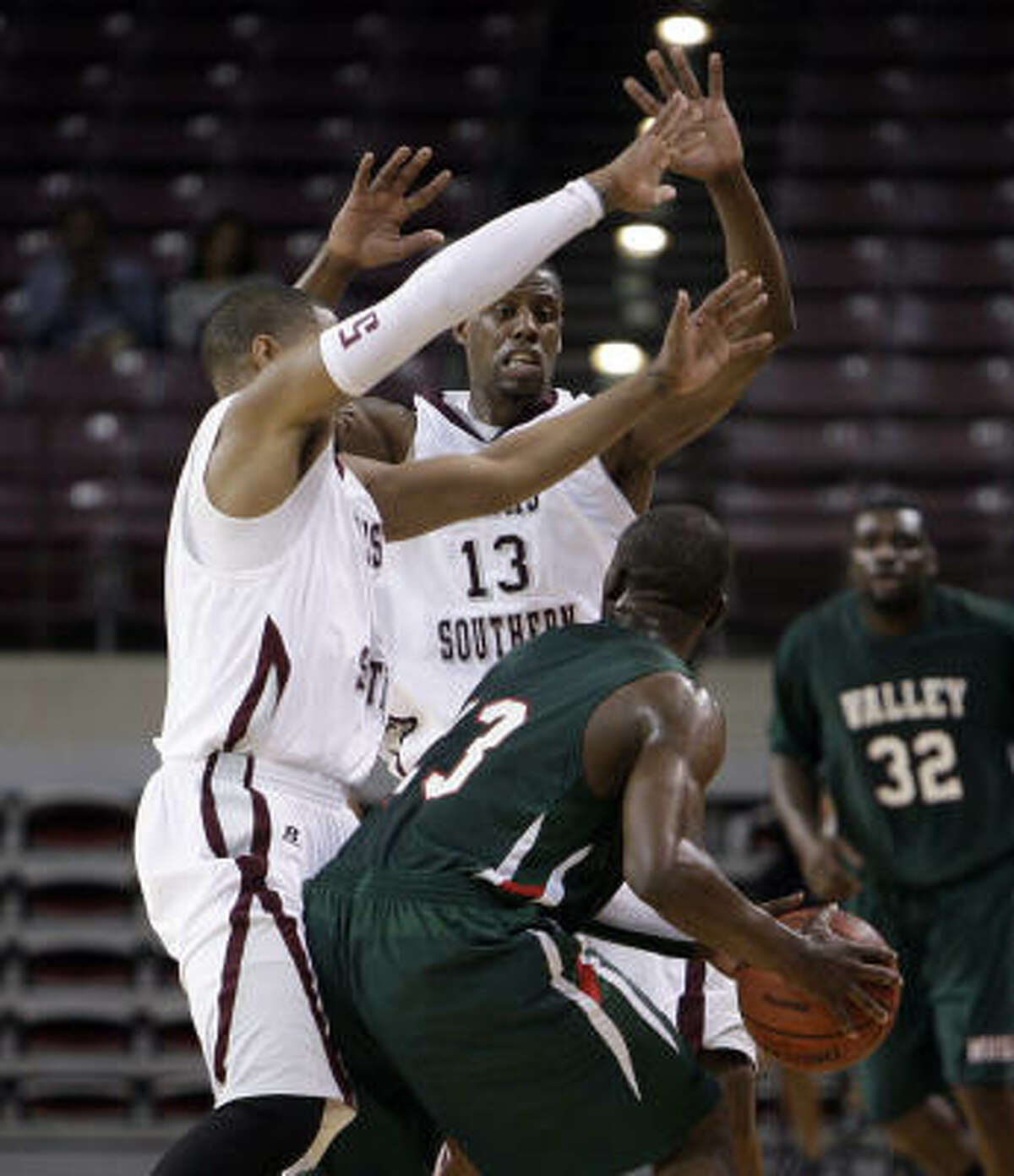 Mississippi Valley State forward Falando Jones (23) is bottled up by Texas Southern guard Harrison Smith (5) and Texas Southern forward Kevin Galloway (13).