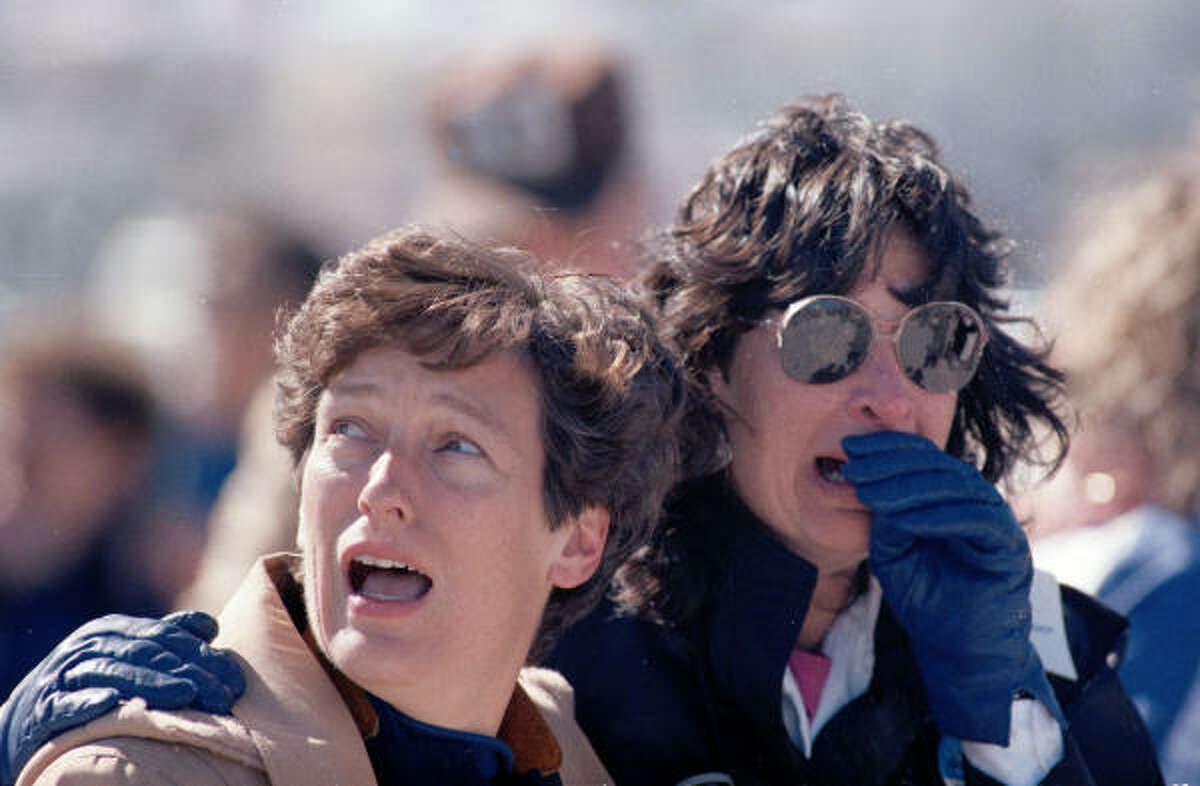 In this Jan. 28, 1986 file photo, two spectators at the Kennedy Space Center, at Cape Canaveral, react to the explosion.