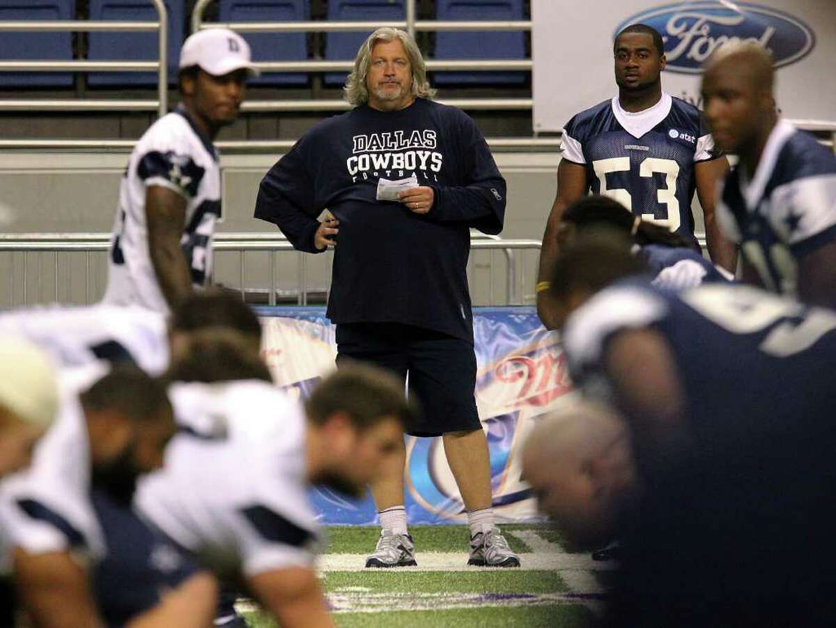 Defensive coordinator Rob Ryan (center) watches his players during a scrimmage at the morning session of the Dallas Cowboys training camp at the Alamodome on Friday, July 29, 2011. Kin Man Hui/kmhui@express-news.net