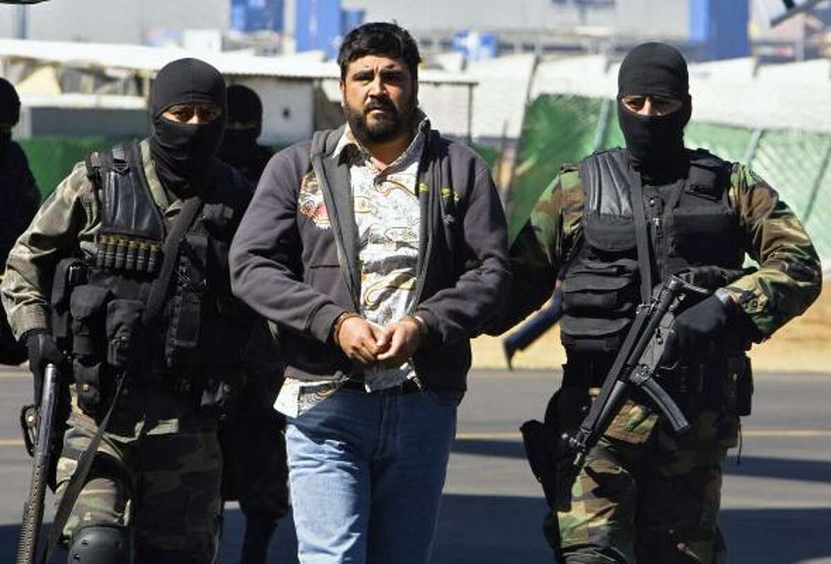 Alleged drug dealer Alfredo Beltran Leyva is escorted by members of the Mexican army after his capture in Culiacan, Sinaloa.
