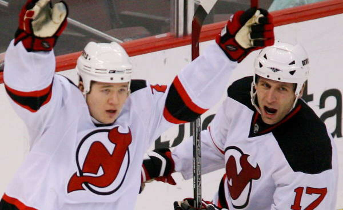 New Jersey's Arron Asham, left, raises his arms to celebrate his second goal in Saturday's game.
