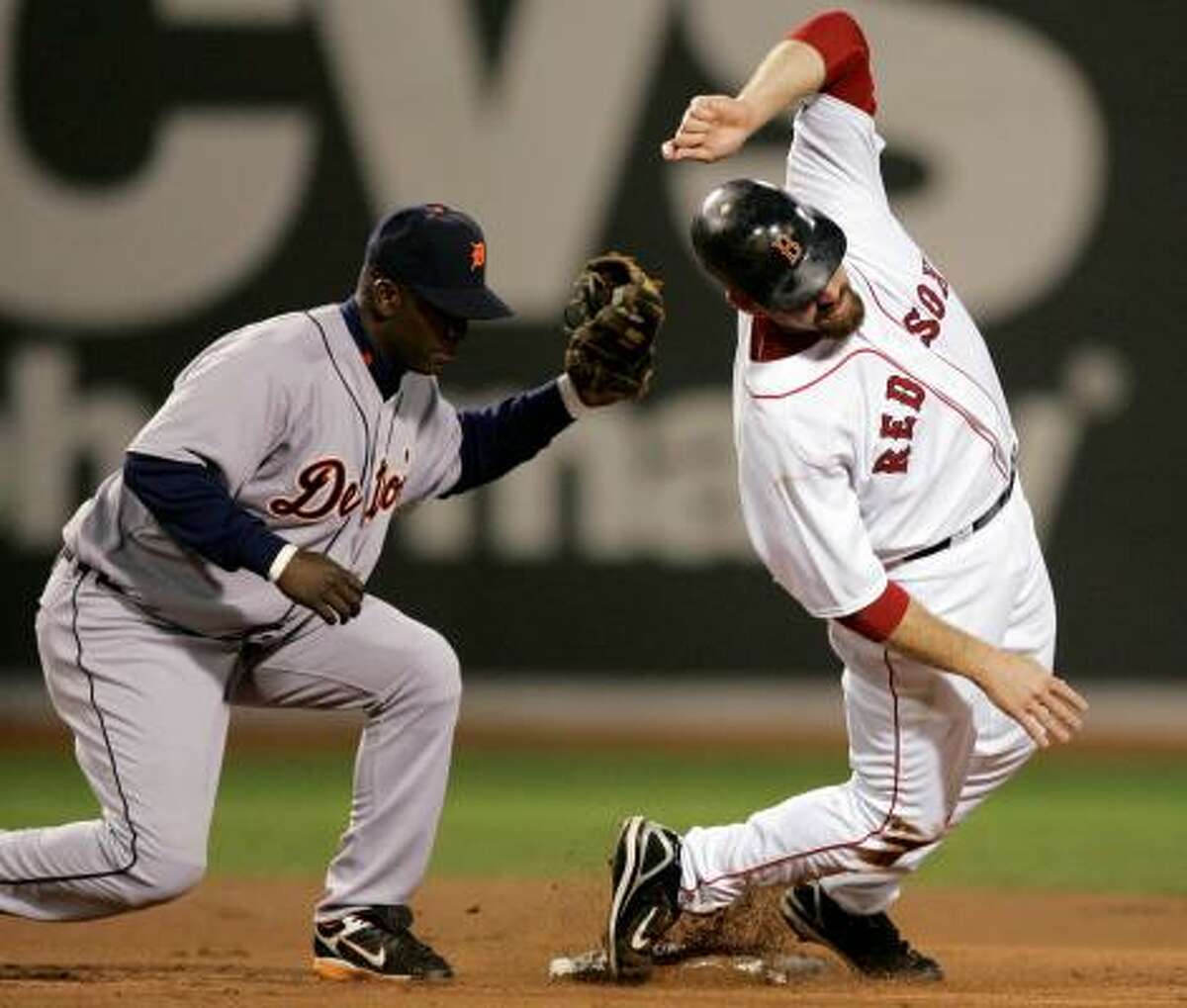 Kevin Youkilis of the Red Sox fails to elude the tag by Tigers shortstop Edgar Renteria on a steal attempt.