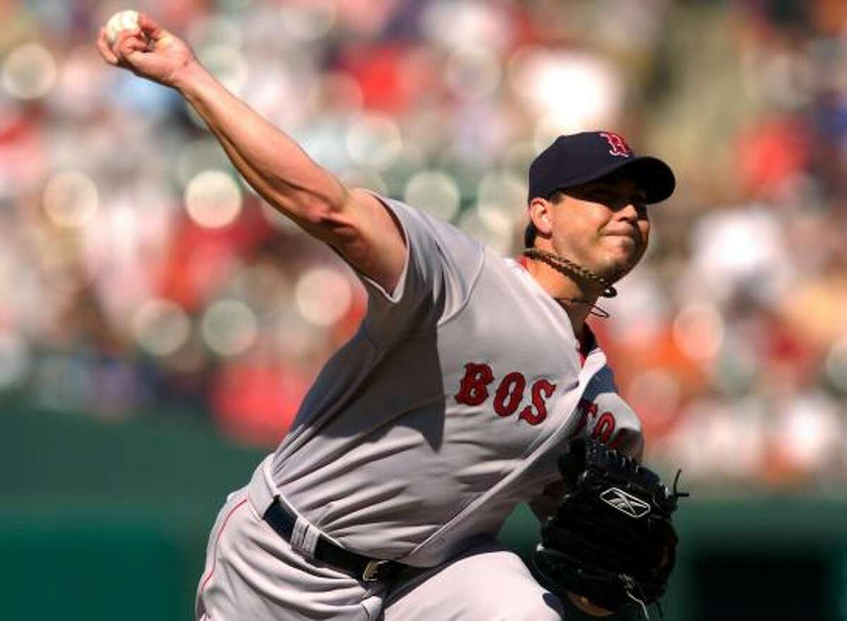 Josh Beckett became the first 15-game winner in the majors after the Red Sox topped the Orioles.
