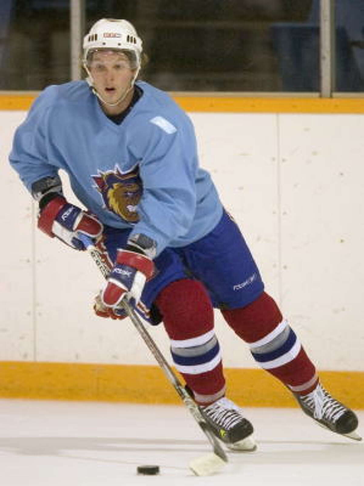 File photo: Hamilton Bulldogs center Corey Locke skates with the puck during the hockey team's practice in Hamilton, Ontario. The Minnesota Wild traded defenseman Shawn Belle to the Montreal Canadiens for Locke and signed minor-leaguer Krys Kolanos to a two-way contrac.