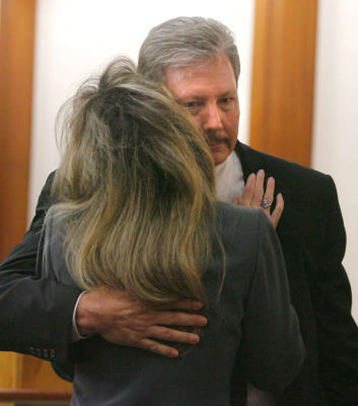 Former Precinct 4 constable's Capt. Tim Cannon hugs his wife, Terri Cannon, during a break Wednesday in his trial on accusations that he tampered with evidence. Jurors today found Cannon not guilty.