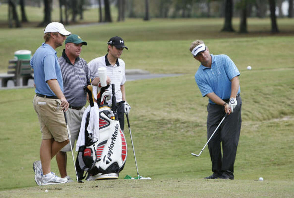 Mathias Gronberg of Sweden, right, practices as, from left, Scott Sajtinal of Houston, Tim Hennessey of New Jersey and Michael Sim of Australia look on at Deerwood Club.