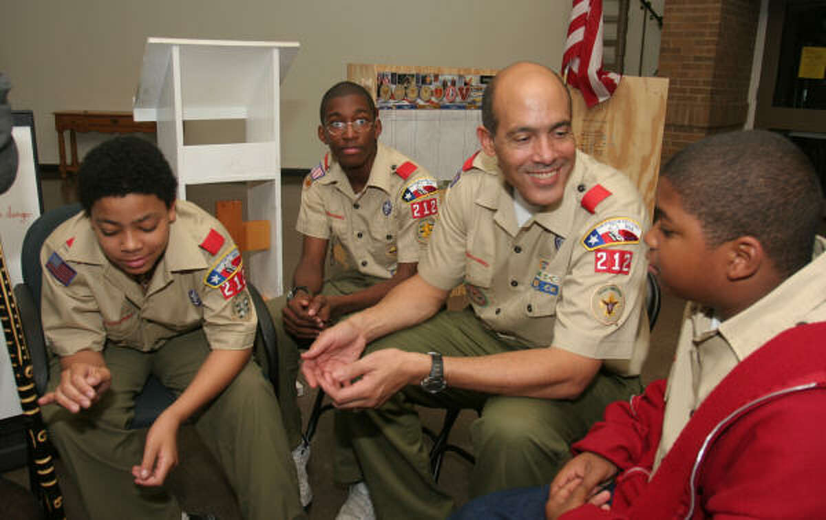 Troop 212 members Mathew Jellins, left, Alexander Denard, Scoutmaster Lionel Jellins and Ashton Ethridge discuss first aid during a meeting at St. James Episcopal Church at 3129 Southmore.