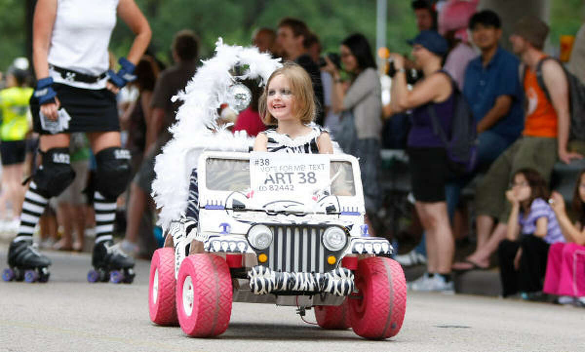 Who says kids can't have their own art car? Lea Lynch smiles at the crowd.