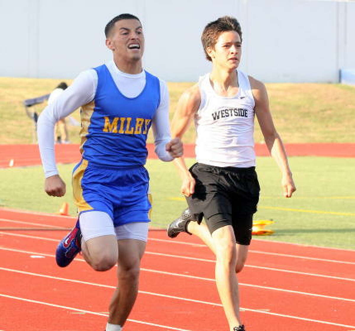 It's a fight between Milby's Eric White, left, and Westside's Christian Aleman in the 400 meters.