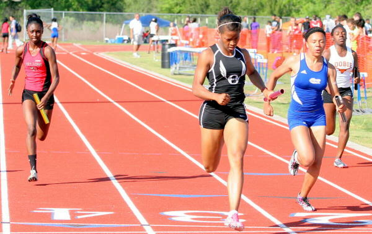 Pearland's Alyssa Dugar, center, makes up ground to cross the finish line first in the 400-meter relay.