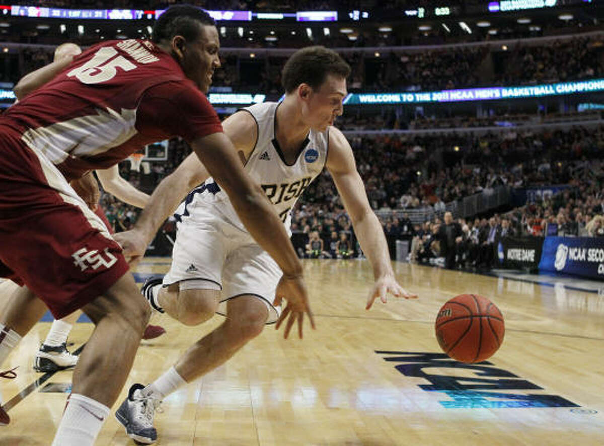 Notre Dame guard Ben Hansbrough and Florida State forward Terrance Shannon, left, chase after a loose ball.