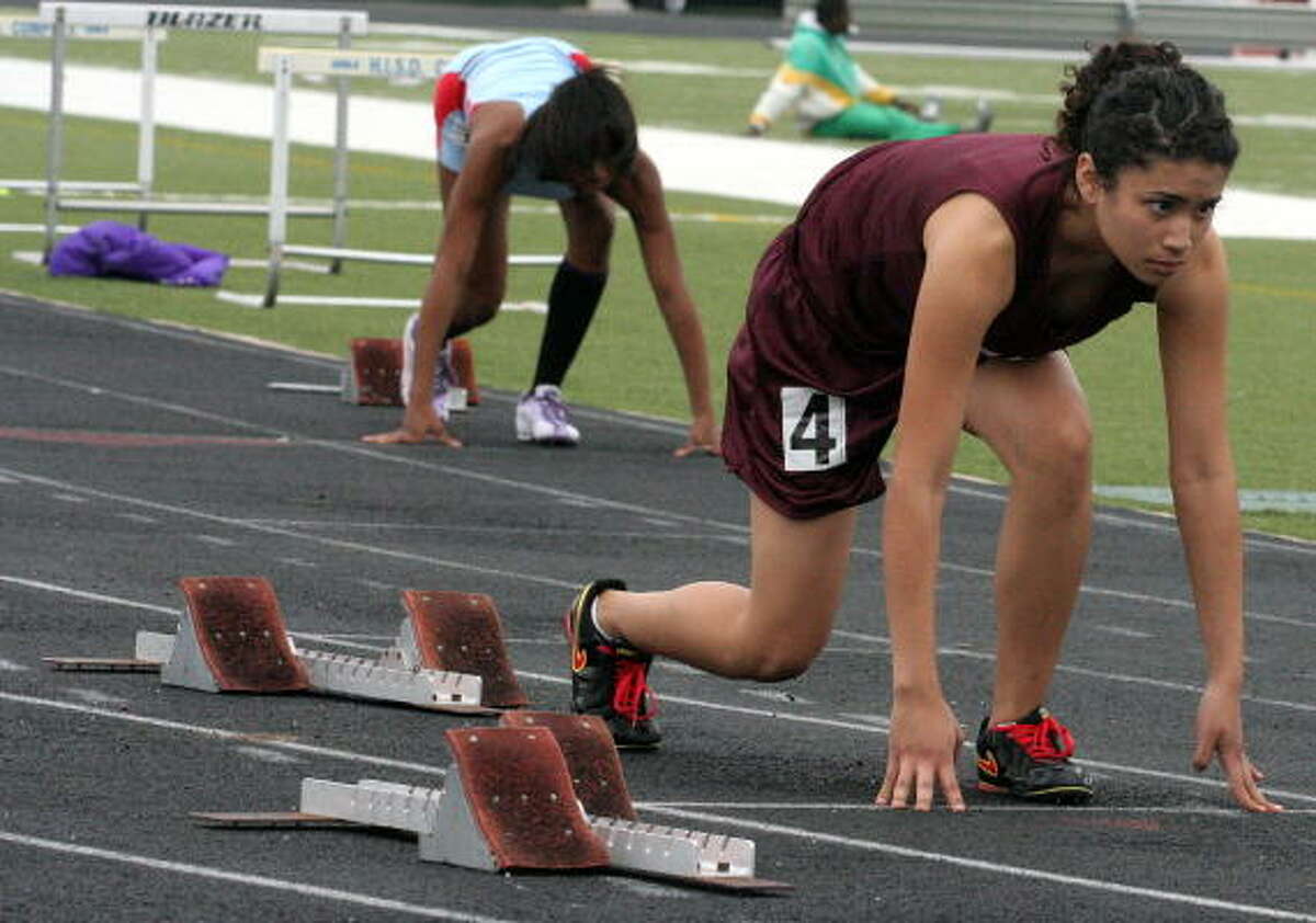Reagan's Jacqueline Torres gets set for heat 5 of the 200-meter run.