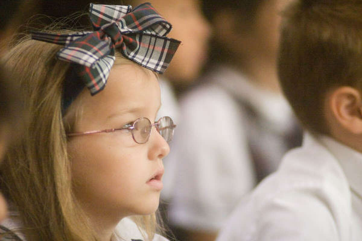 Taylor Rechter, 6, an Awty first grader, watches the goings-on at the school's 50th anniversary celebration.