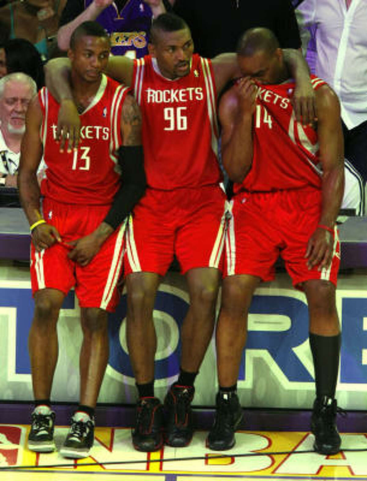 Ron Artest, center, supports teammates Von Wafer, left, and Carl Landry at the end of a disappointing 89-70 Game 7 loss to the Lakers on Sunday at Los Angeles.