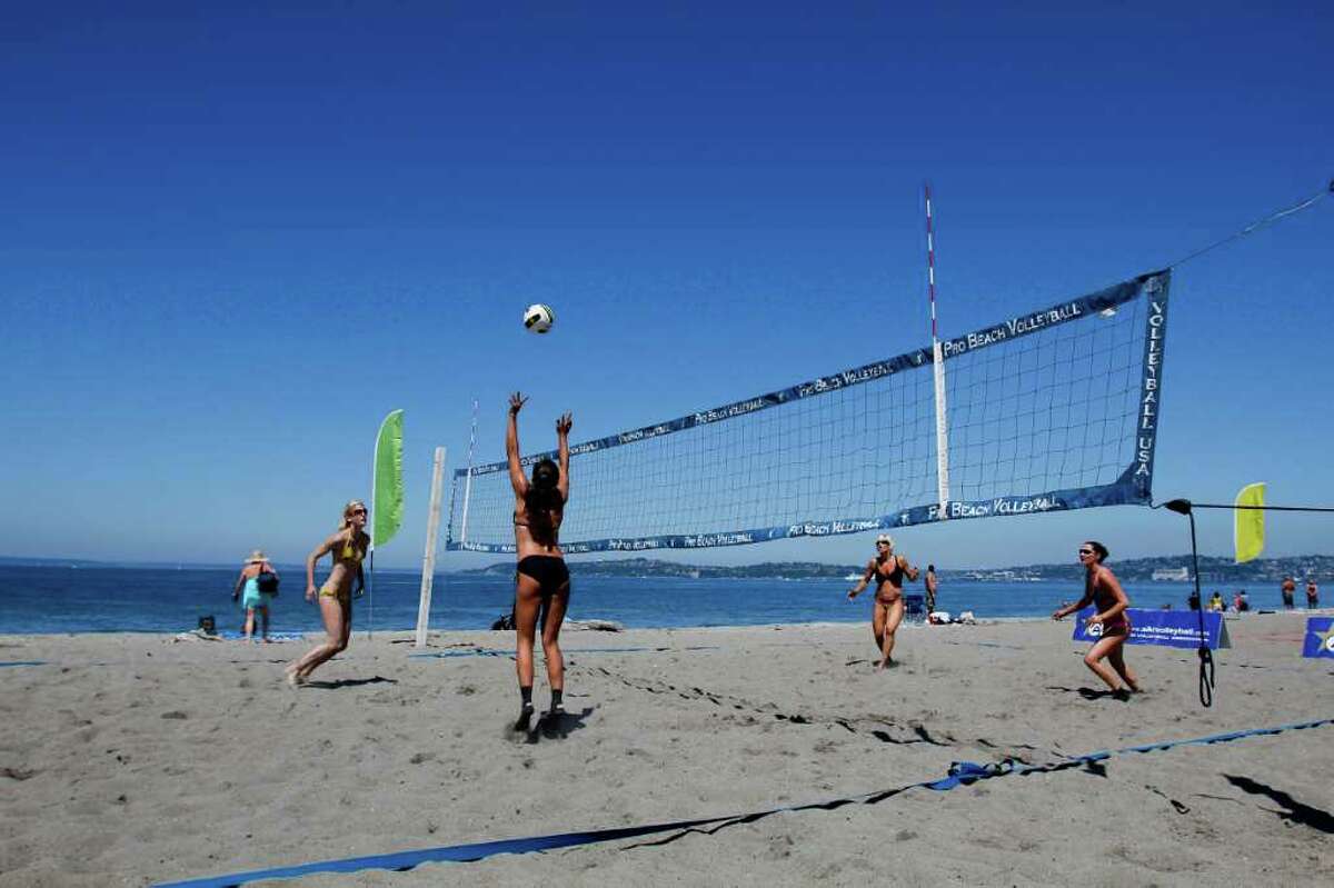 From left: Shauna Metschke, Naomi Fowler, Gena Aytch and Kamila Nowak play in a volleyball tournament at Alki Beach in Seattle on Saturday, July 30, 2011. Saturday's temperatures climbed into the high 70s around the region, and although there's a chance of rain Sunday, once that passes forecasters say we're at the start of at least a week of days just like Saturday. It's not much, but we'll take it.