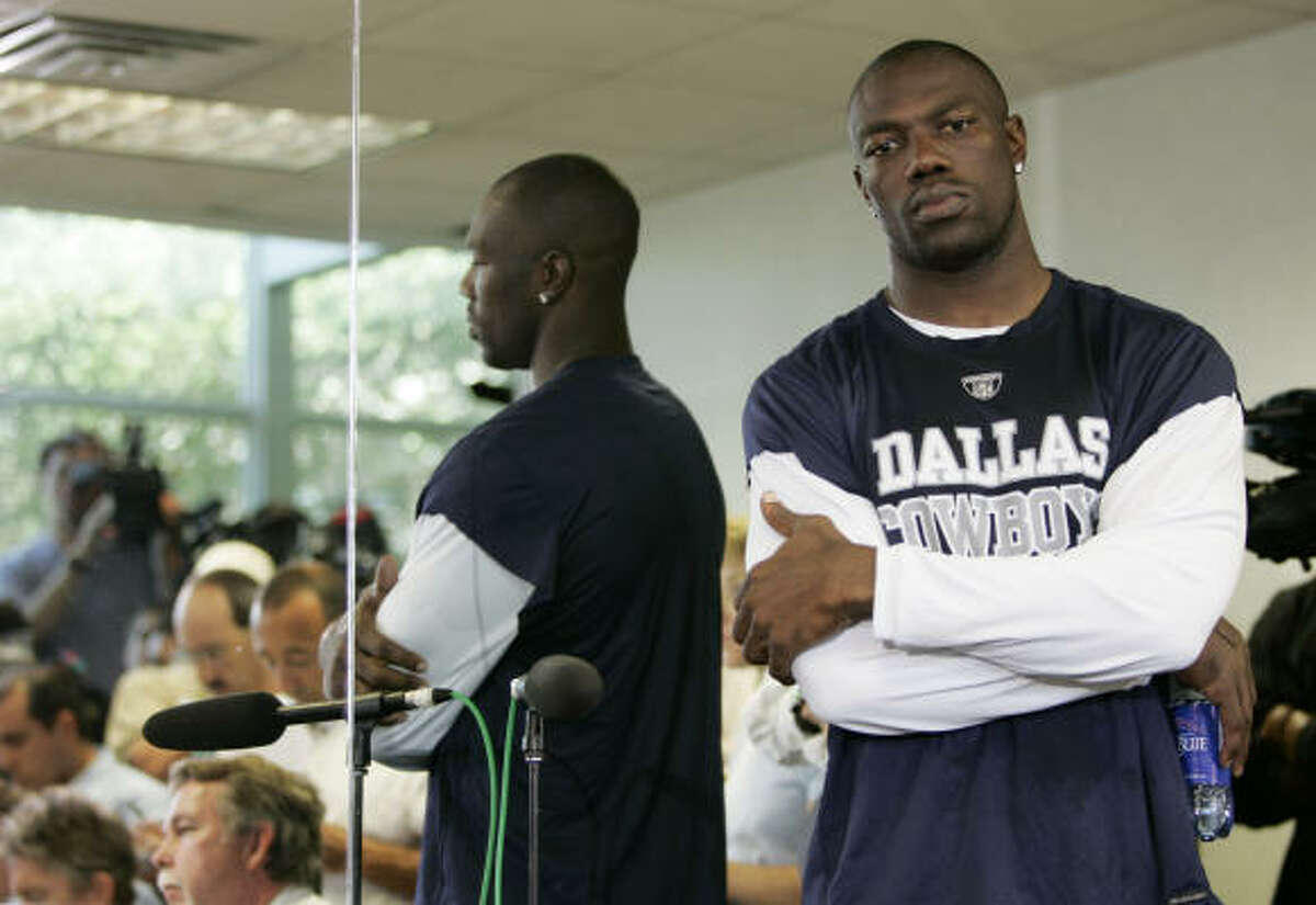 Dallas Cowboys' Terrell Owens stands by as his publicist talks with reporters during a news conference at the Cowboys training facility.