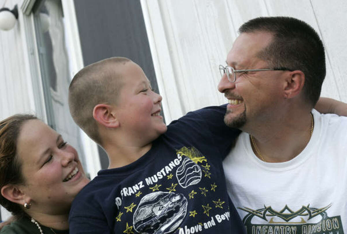 Wounded soldier Scott Morgan with his wife, Melanie, and his son, Hunter, age 6, at their San Antonio home.