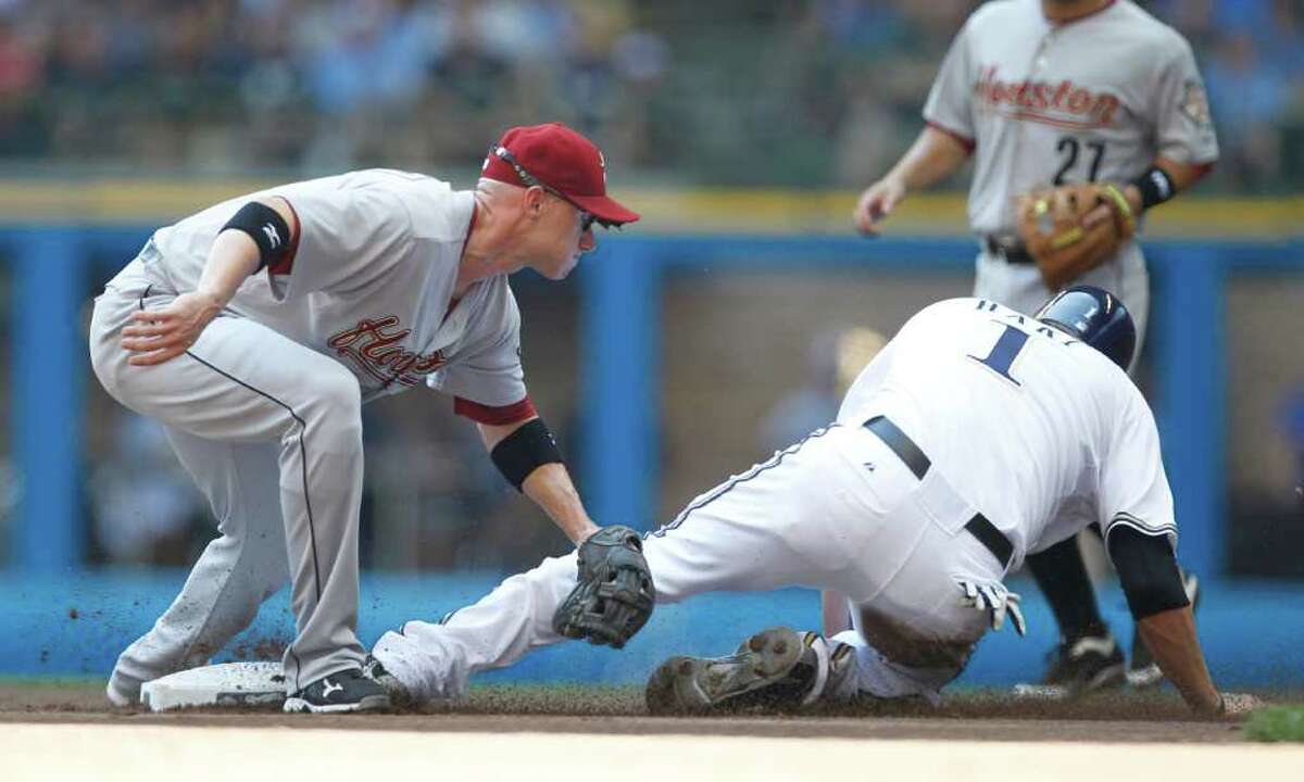 Milwaukee Brewers' Corey Hart, front right, is tagged out by Houston Astros' Clint Barmes while trying to steal second base during the first inning of a baseball game on Sunday, July 31, 2011, in Milwaukee.