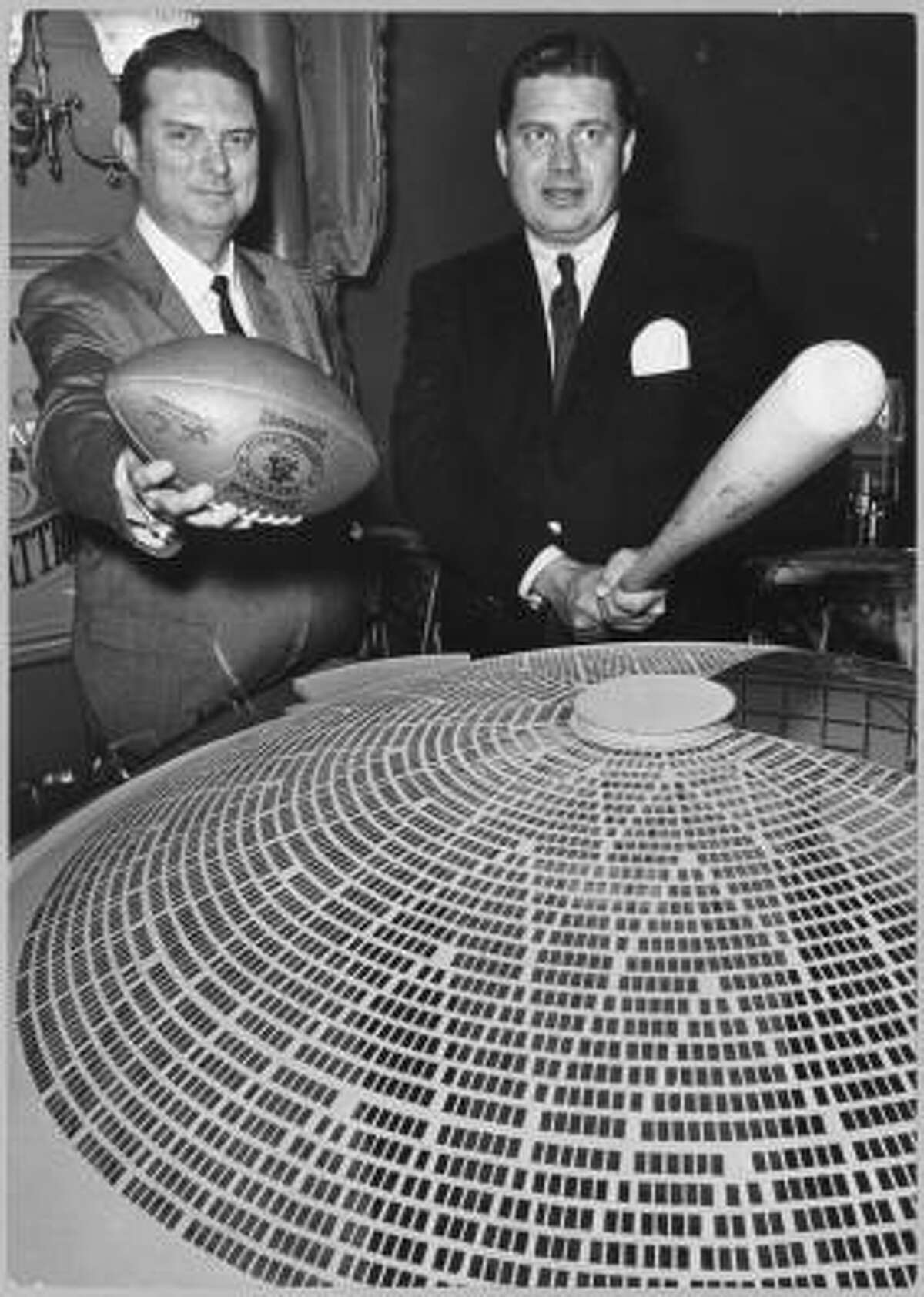 In 1961, Bud Adams, right, owner of the Oilers, poses with Roy Hofheinz, president of the Colt .45s, as they make a pitch to voters for building the proposed domed stadium. At the time, Adams said the stadium would assure the continuance of professional football and baseball in Houston.