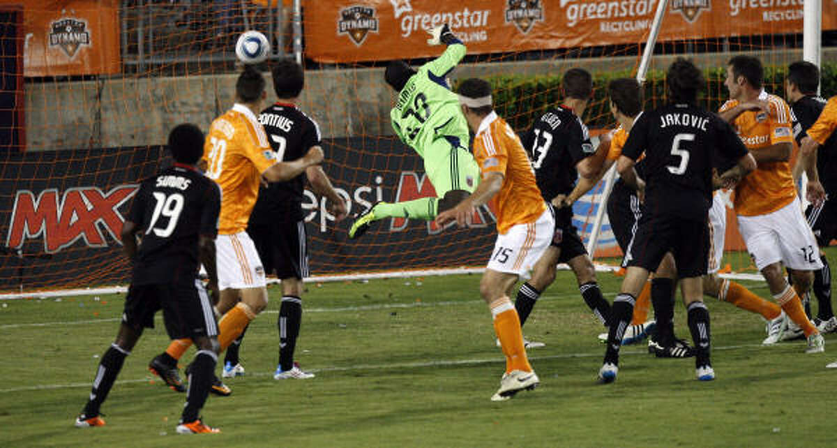 Dynamo forward Will Bruin (12) connects on a header that eludes D.C. United goalkeeper Bill Hamid in the second half for Bruin's third goal.