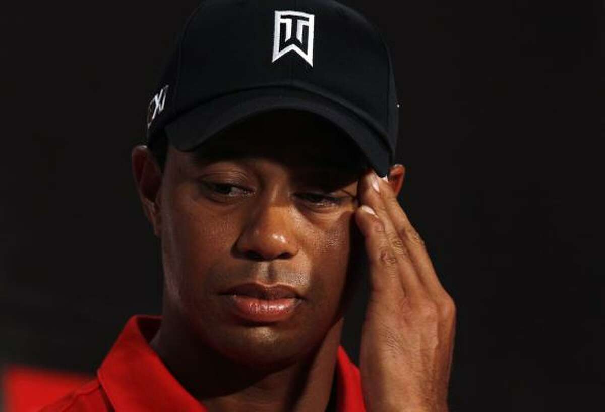 U.S. golfer Tiger Woods reacts during a news conference as part of his Asian tour at Mission Hill Dongguan club house, in Dongguan, southern China's Guangdong province, Tuesday, April 12, 2011. Woods will visit Beijing and Seoul during the tour.