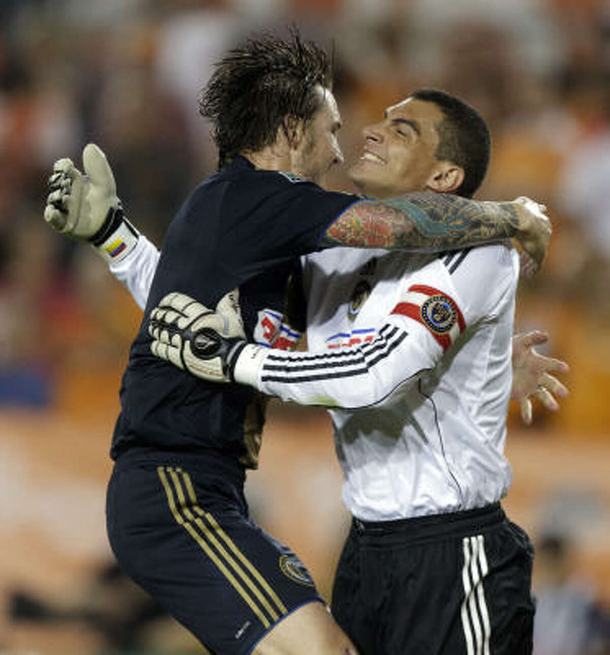 Union goalkeeper Faryd Mondragon, right, receives congratulations from teammate Danny Califf at the final whistle as they defeated the Dynamo, 1-0, at Robertson Stadium.