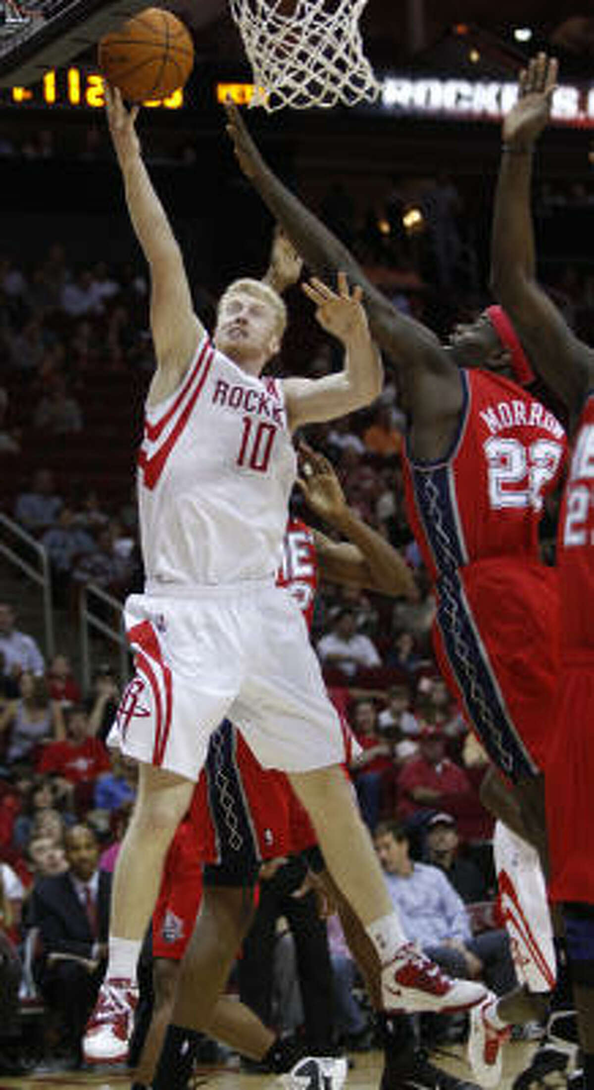 Rockets forward Chase Budinger shoots over New Jersey's Anthony Morrow during the second quarter.
