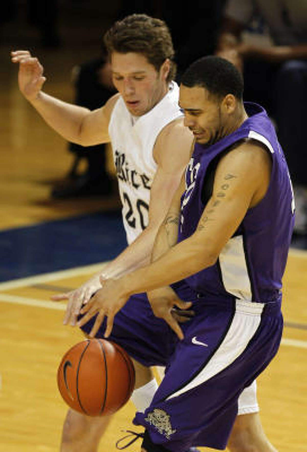 Rice's Lucas Kuipers, left, knocks the ball away from TCU's Sammy Yeager during the first half.