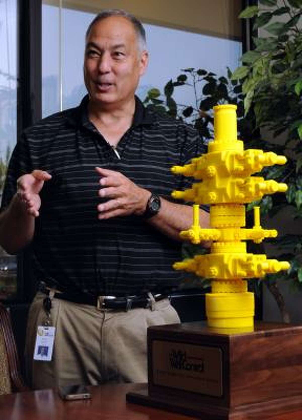 Randy Kubota, Wild Well Control's general manager of marine engineering, shows a model of an emergency containment system made to respond globally to offshore oil spills.