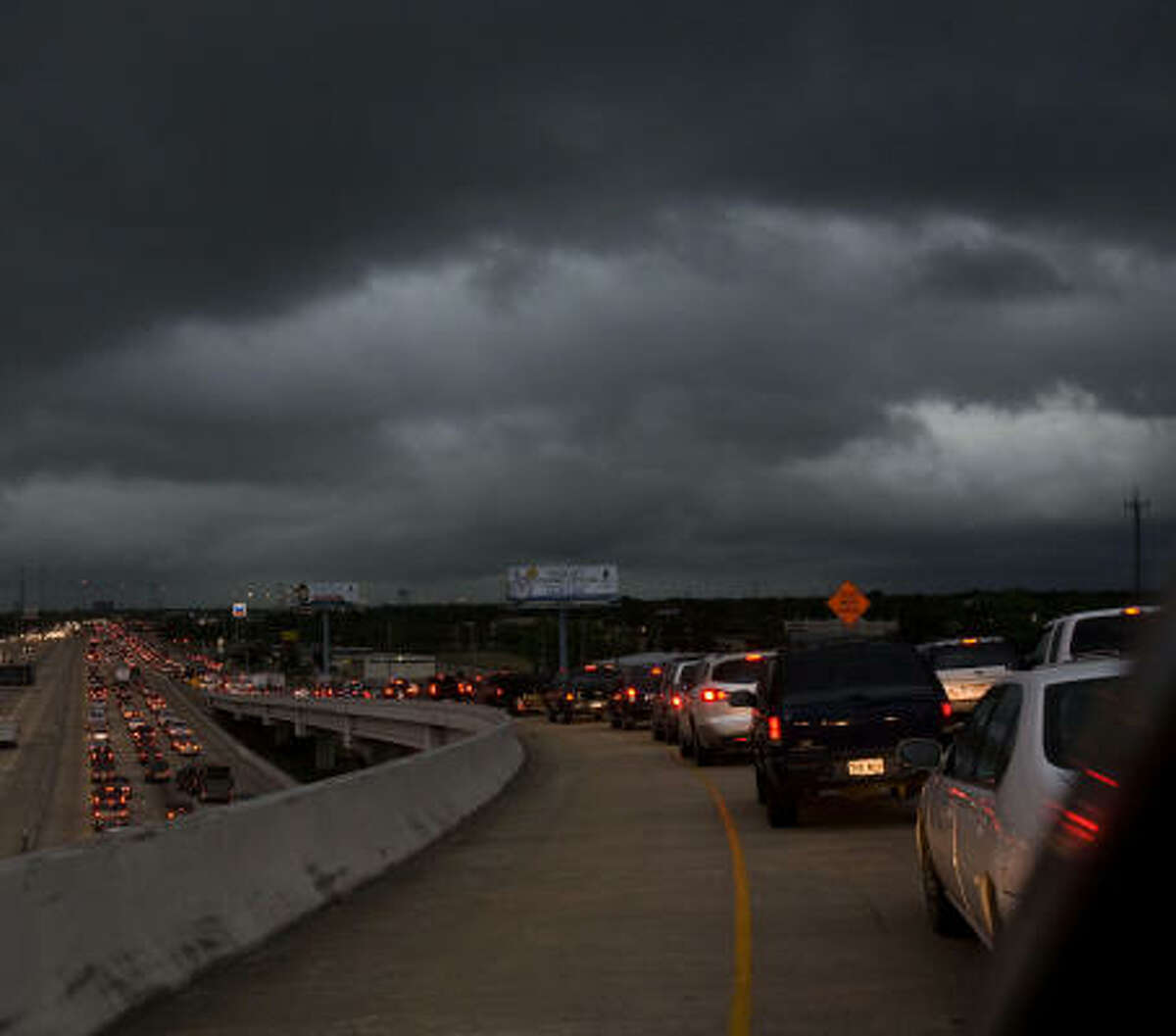Traffic backs up on the Beltway 8 ramp to U.S. 290 northbound as a storm moves into the Houston area. There's also trouble ahead for Texas roads, lawmakers say.