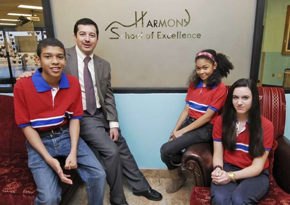 CHARTER SCHOOL: Harmony School of Excellence principal Gurol Duman visits with students Christopher Head, left, his sister Kiana Head and Anna Irwin, far right.