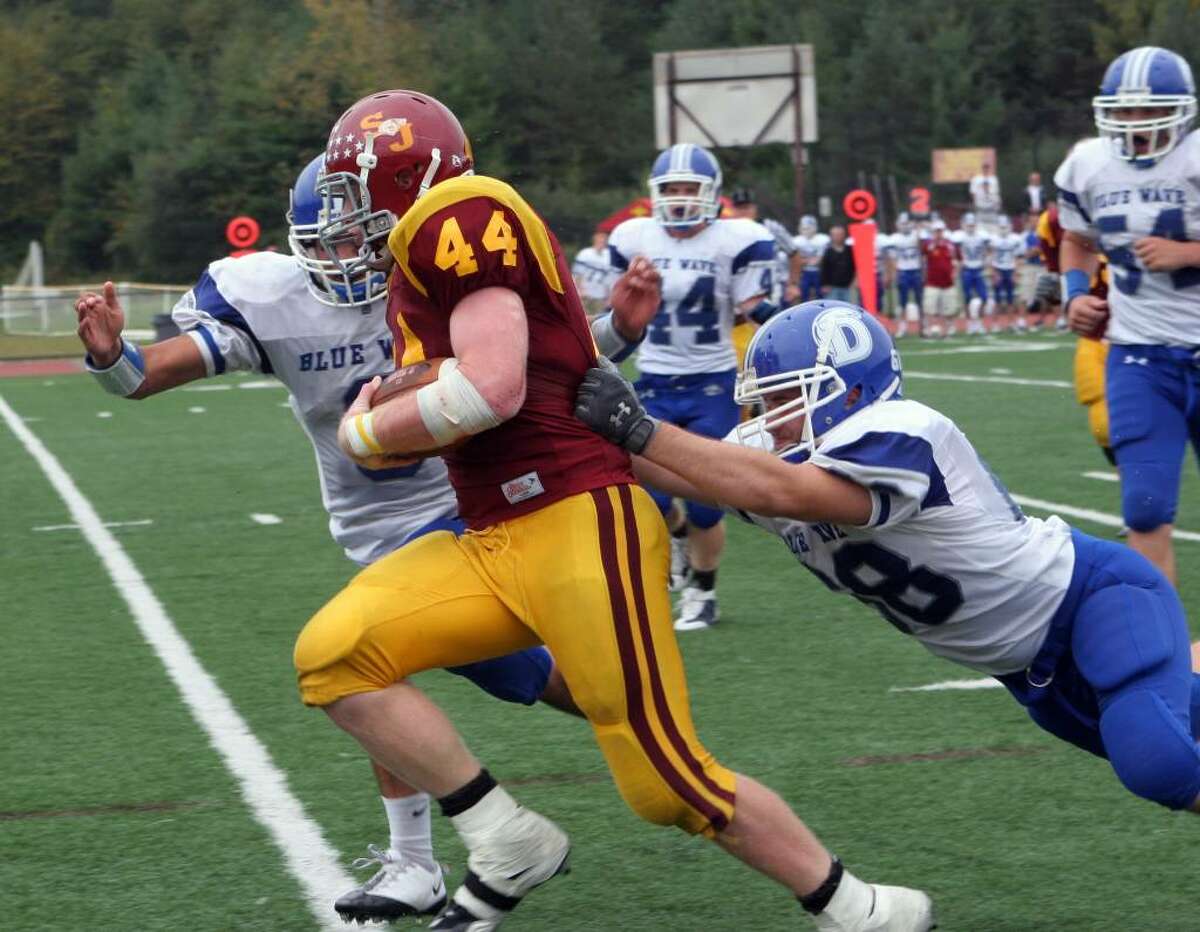 St Joseph's Tyler Matakevich (44) eludes Darien's defenders in the 4th quarter of the Saturday, Oct.3,2009 football game in Trumbull. St Joseph won 21-10.