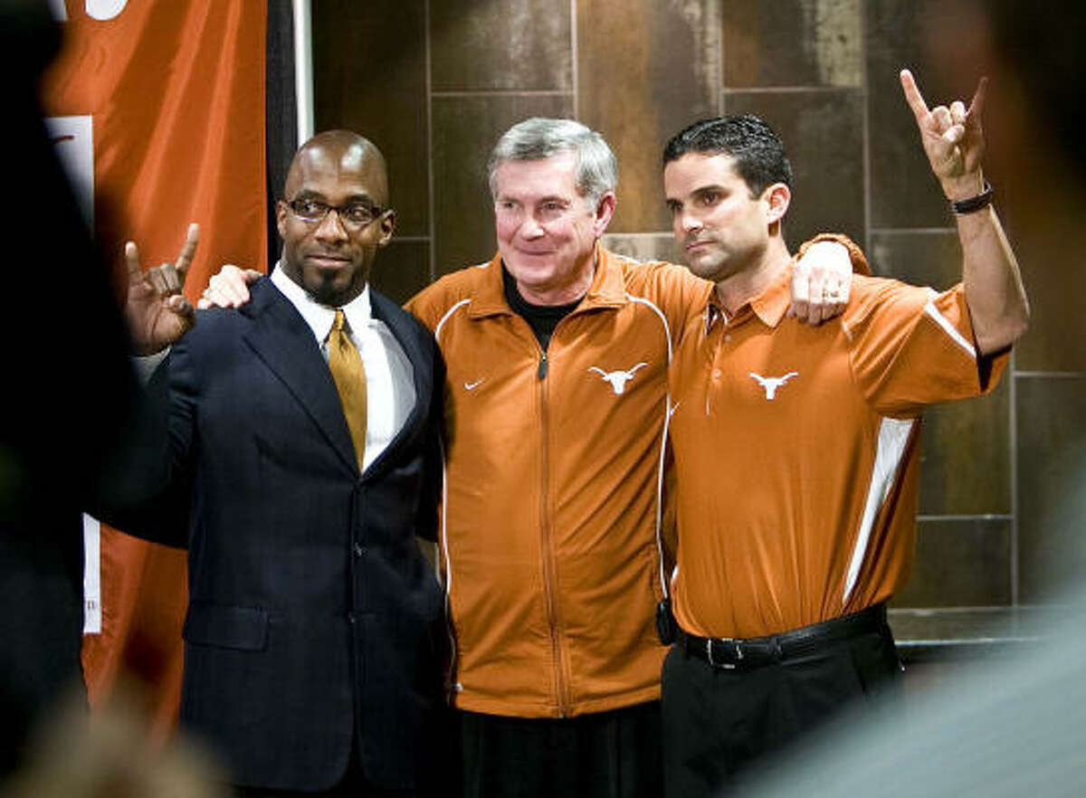 Texas coach Mack Brown, center, introduces new defensive coordinator Manny Diaz, right, and strength/conditioning coach Benny Wylie.