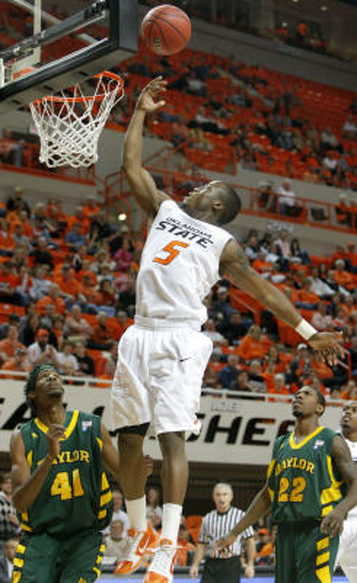 Oklahoma State's Reger Dowell (5) and the Cowboys rolled to a 71-60 win over Baylor.