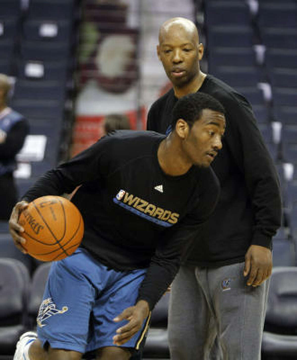 Former Rockets guard Sam Cassell, back, is currently an assistant coach with the Washington Wizards.