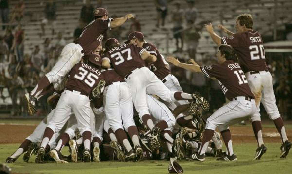 A&M players form a dog pile as they celebrate their 11-2 victory over Florida State on Monday night.