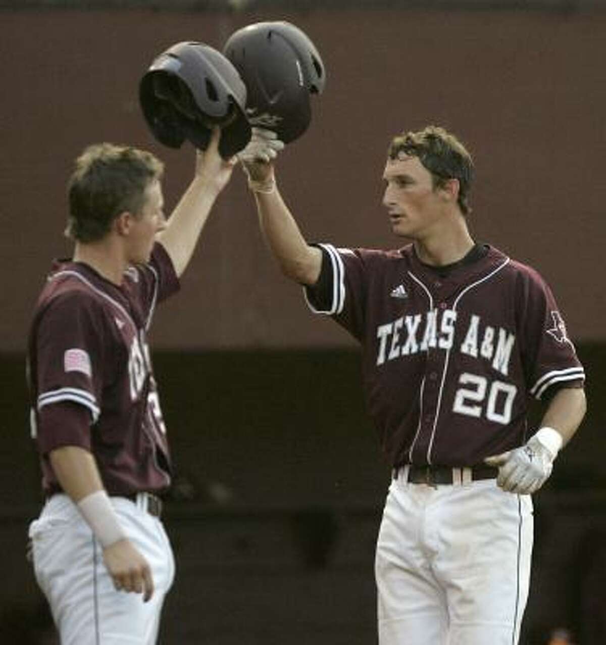 A&M's Adam Smith celebrates with Jacob House, left, after hitting a home run in the second inning on Monday night.