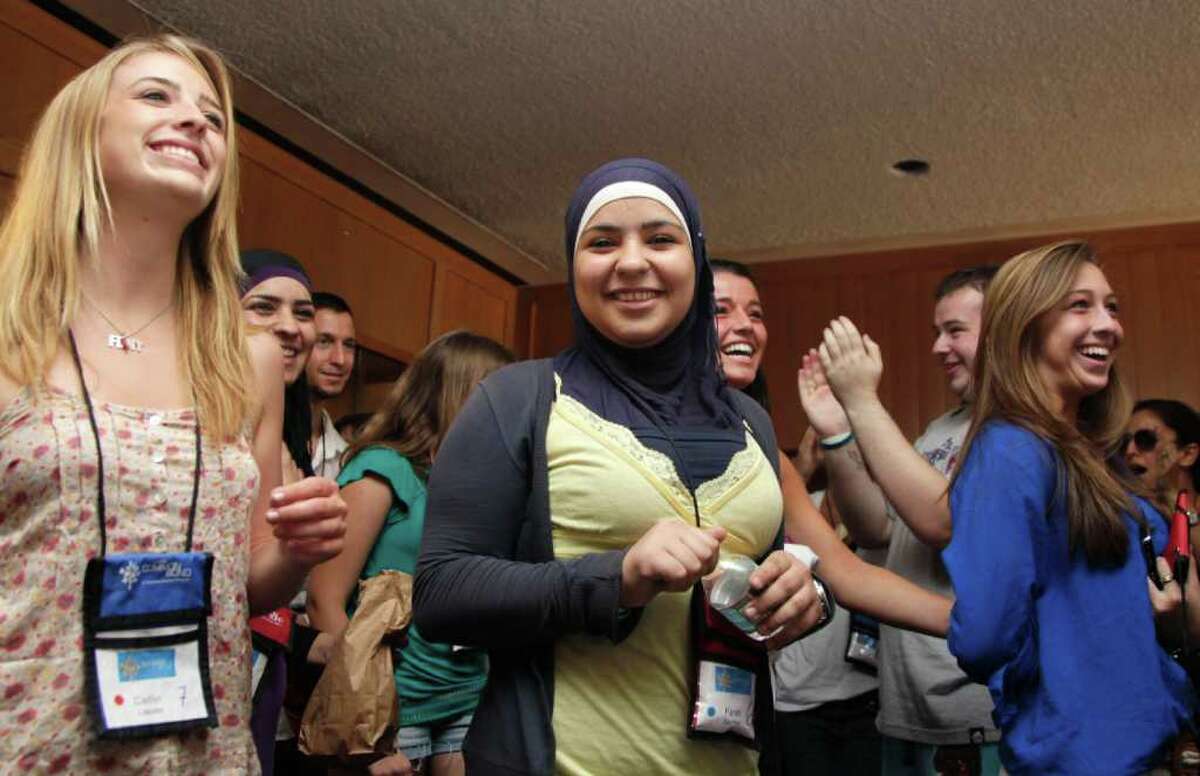 From left, Caitlin Leavey, of New York, Farrah Sarrawi of Palestine, Francesca Picerno of the US, and Allison Stahlman, are applauded during Project Common Bond on the Foxcroft School campus in Middleburg, Va., Wednesday, July 27, 2011. Project Common Bond brings together offspring of 9/11 victims with other teens who have lost family members to acts of terror around the world. (AP Photo/Carolyn Kaster)