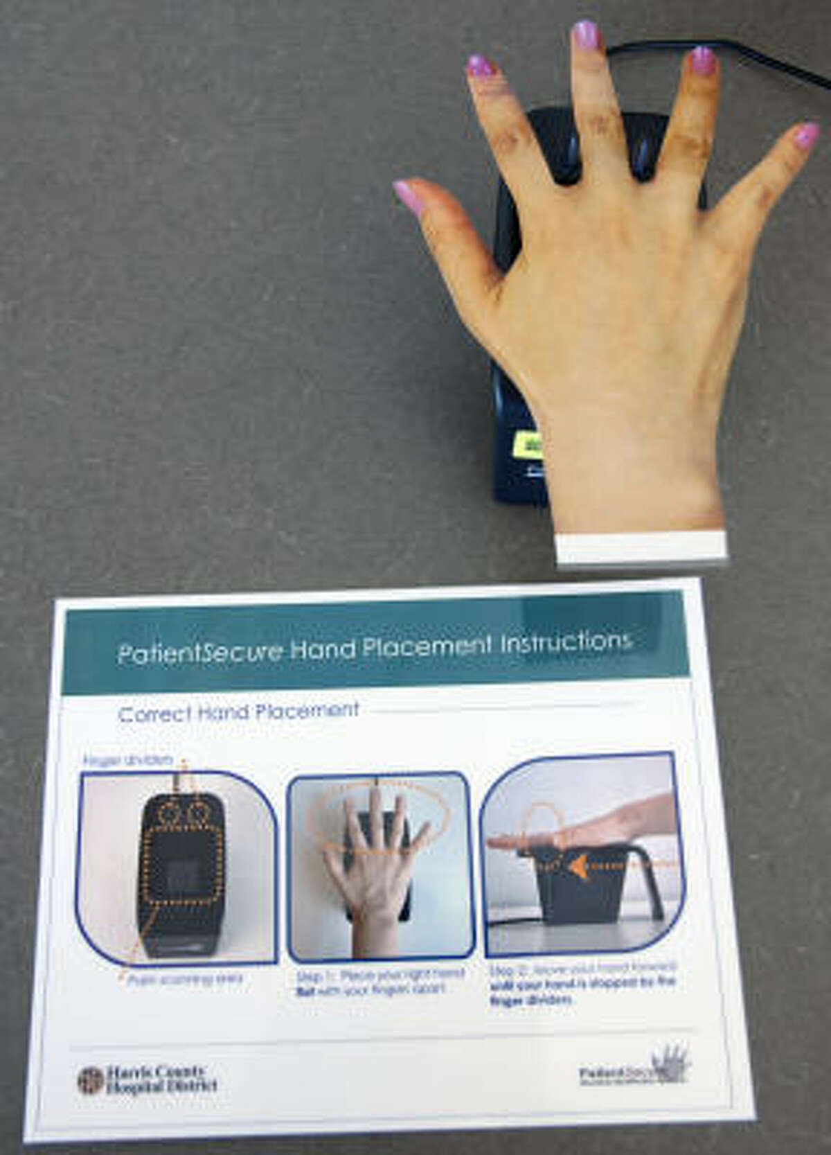 Directions for using the biometric palm scanner are illustrated at Martin Luther King Health Center, where the scanners were unveiled on Tuesday.