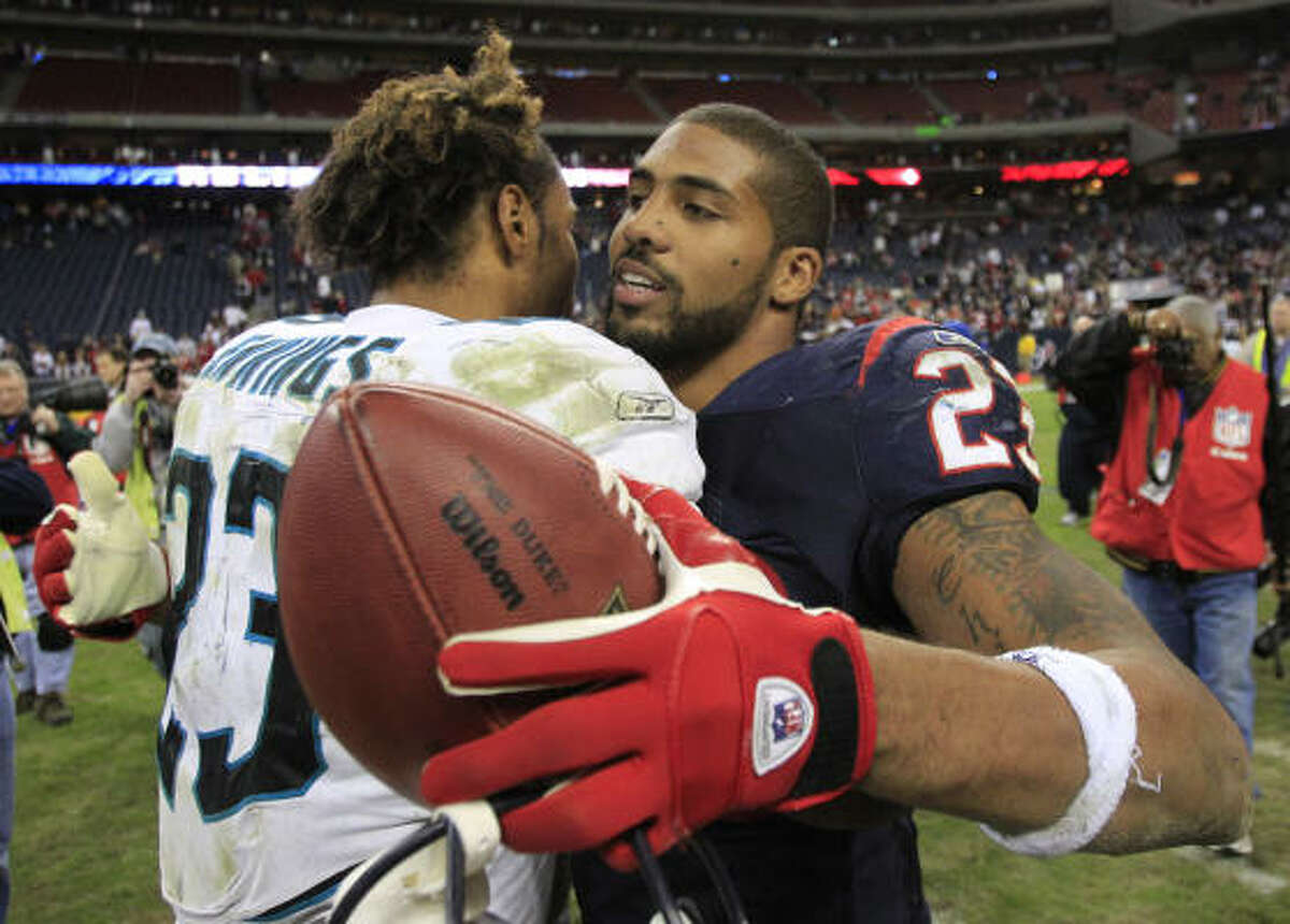 Texans running back Arian Foster (23) and Jacksonville's Rashad Jennings embrace after both had big days.
