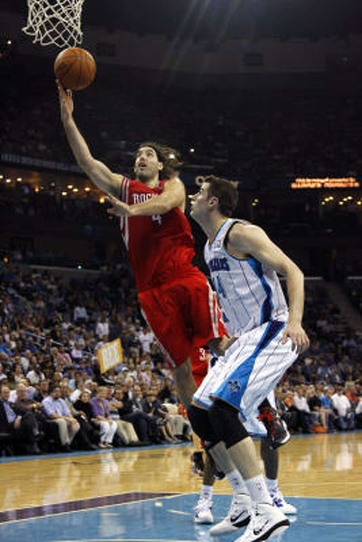 Rockets power forward Luis Scola drives to the basket against Hornets power forward Jason Smith.